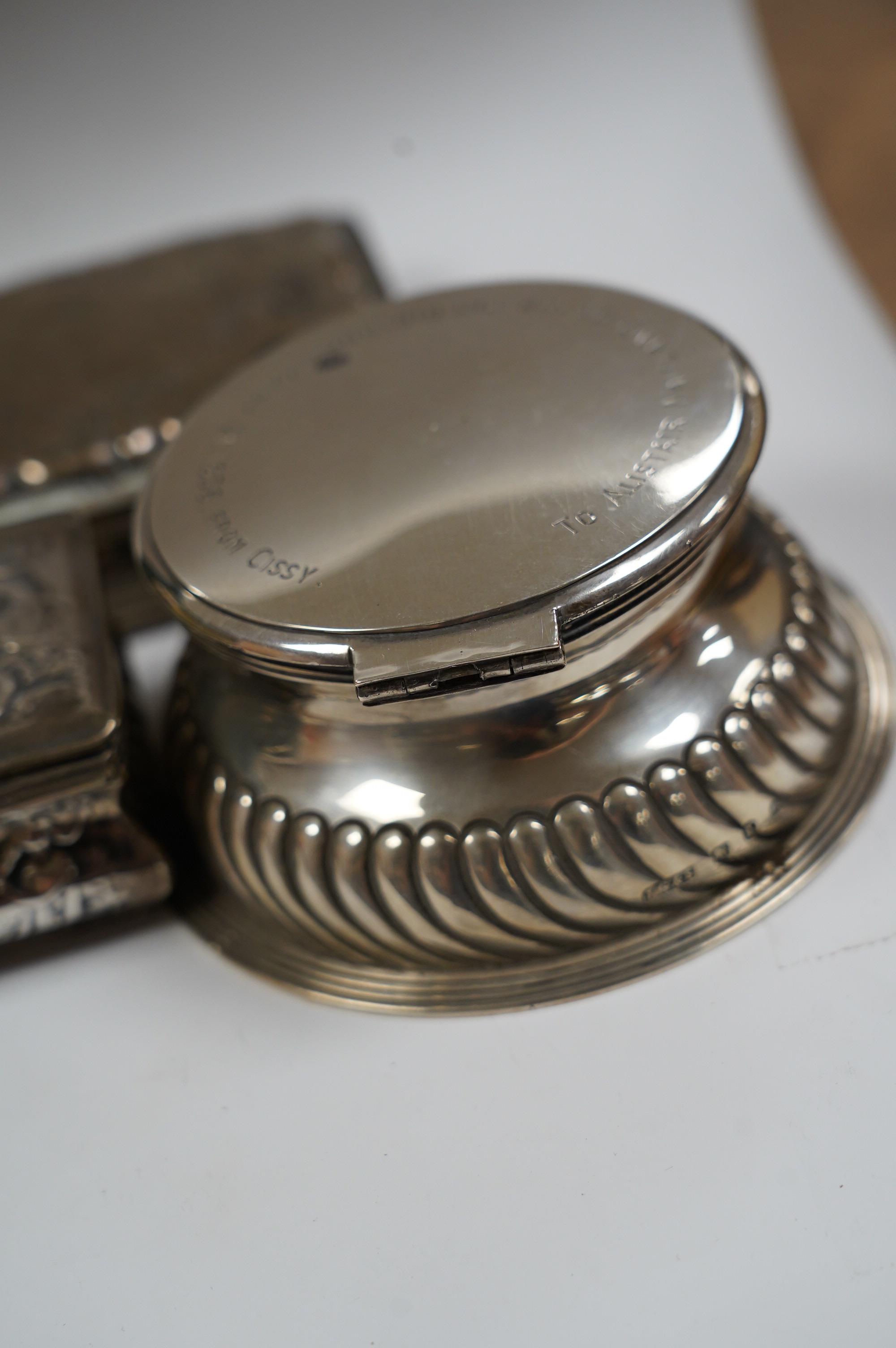 A late Victorian demi-fluted silver circular inkwell, with later engraved inscription, Birmingham, 1891, base diameter 11.4cm and two continental white metal boxes. Condition - poor to fair